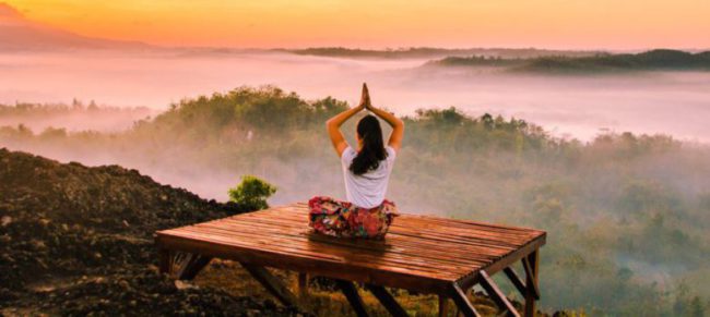 woman meditating on a mountain