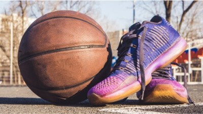 sneakers and a basketball on the ground