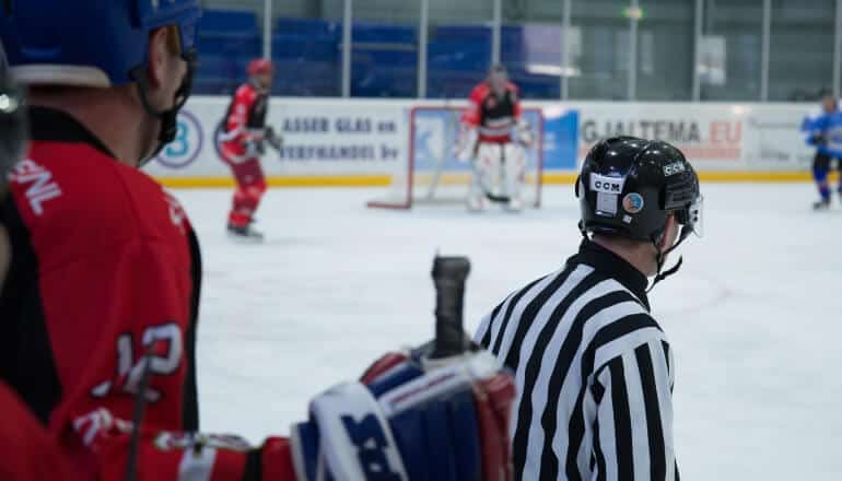 hockey player behind ref