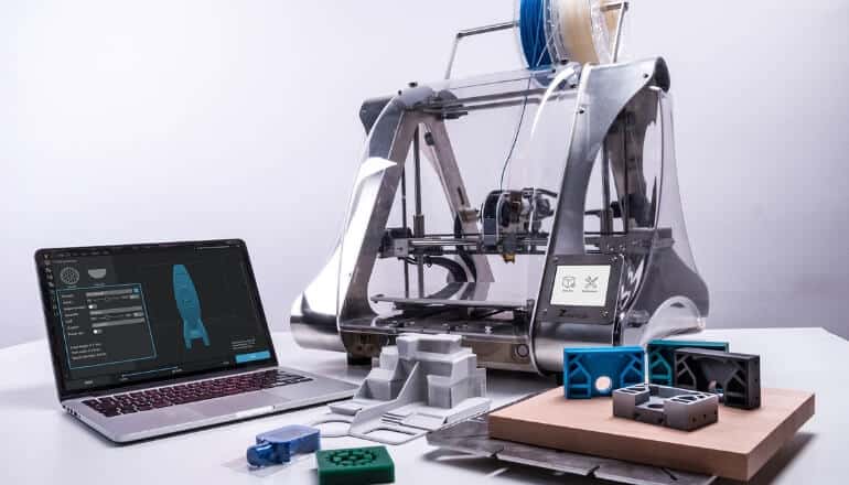 3d printer on table with laptop