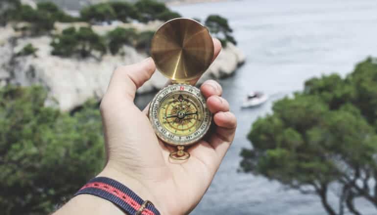 man holding compass