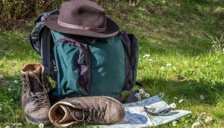 hiking equipment on the ground including a hiking hat