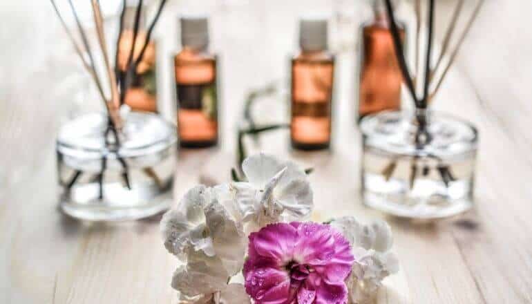 essential oils and flower on a table