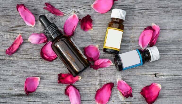 3 essential oils and flower petals