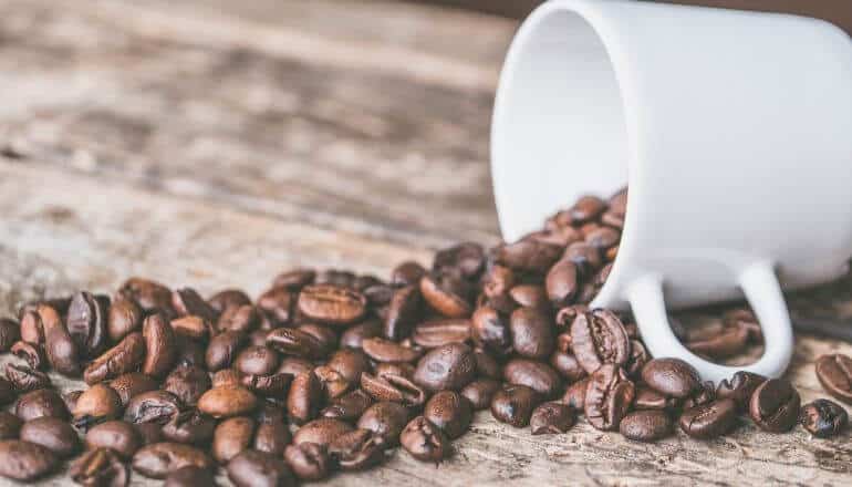 coffee beans spilled from mug