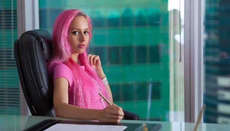 woman in pink at desk