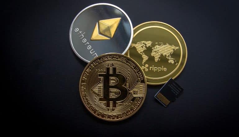 3 crypto coins on a table