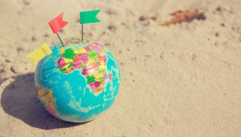 toy globe on the beach