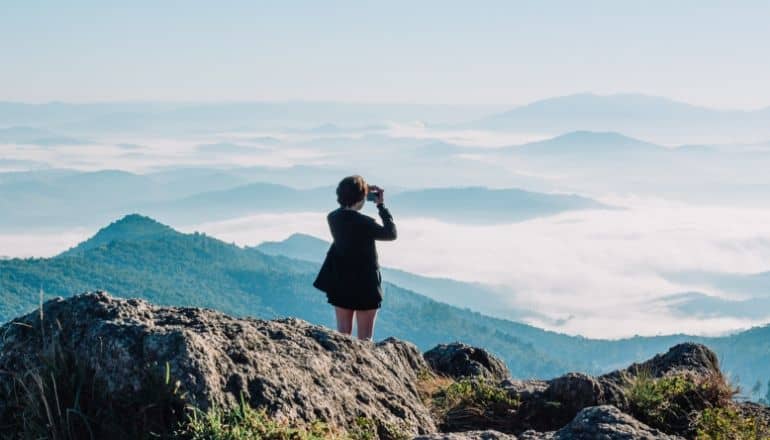 woman looking over mountain