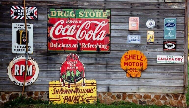 ads and signs on a wood wall