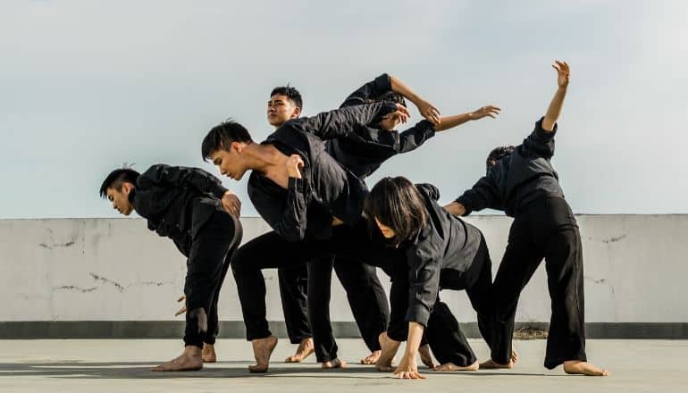 men in black dancing