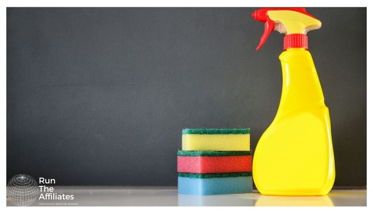 stack of sponges and a yellow spray bottle of cleaner