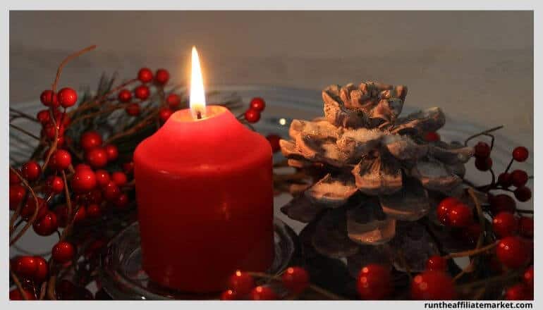 candle next to pinecones