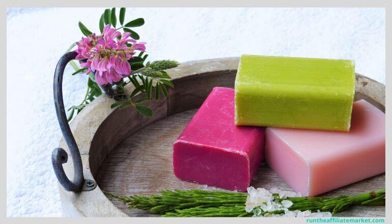 multicolored bars of soap in a wooden tray