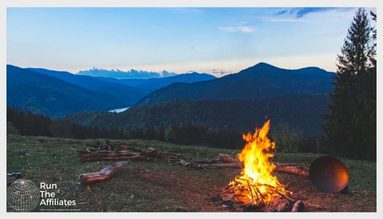 campfire against a pictureque mountain backdrop