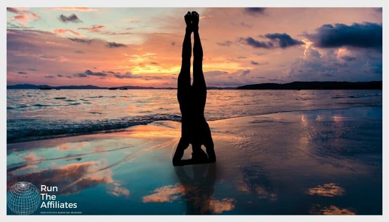 woman in a yoga pose on the beach