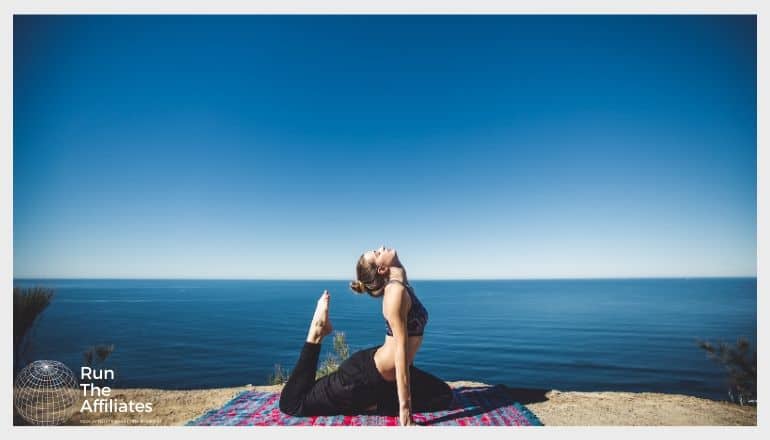 woman in a yoga pose in front of a deep blue sky