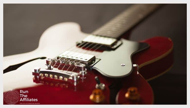 close up image of a rad and gold guitar