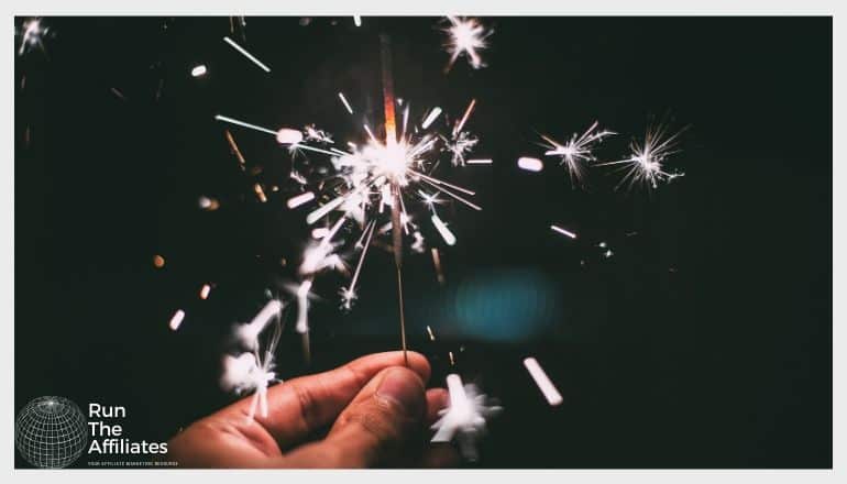 man holding a sparkler at a party