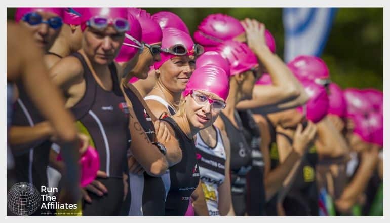women in swimgear awaiting the start of a triathlon