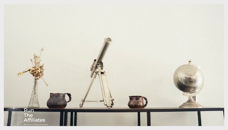 metal telescope and globe on a mantle