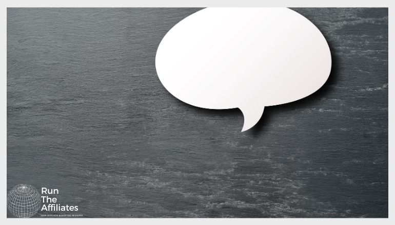 chat bubble against a dark wooden background