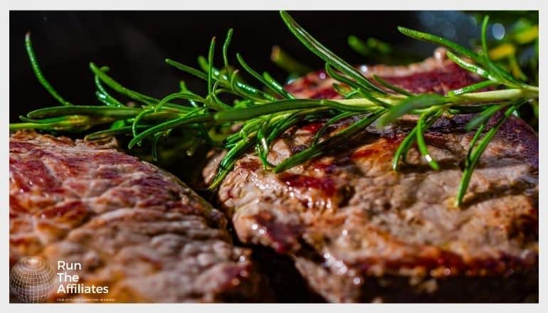 grilled steak with a sprig of rosemary laying on it