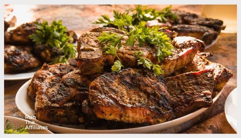 plates of grilled steak stacked with a parsley garnish