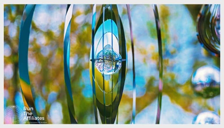 hanging piece of metal art with reflective surfaces fashioned into vertical rings