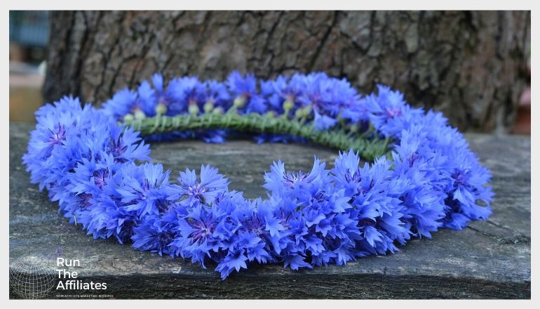 wreath made of blue flowers laying on a rock