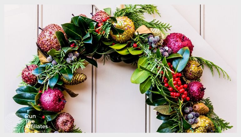 wreath hanging on a door. the wreath is made of leaves and fruit