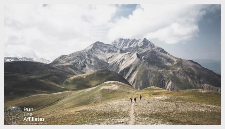 group of hikers heading towards a mountain range