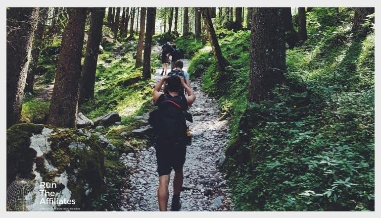 group of people hiking through a forest