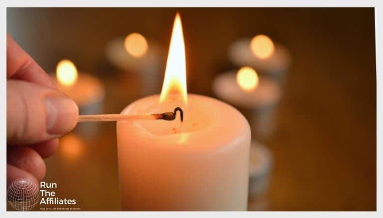 woman lighting a candle with a match