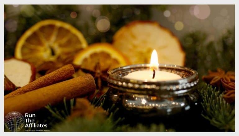 candle surrounded by candied fruit and spices