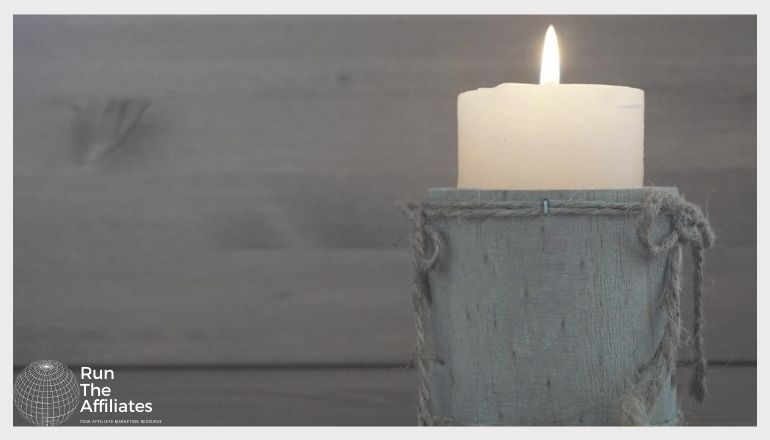 candle in front of a wooden wall