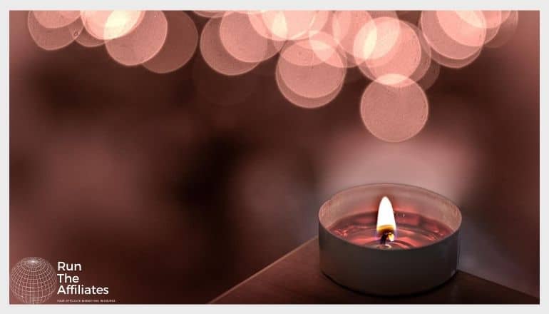 close up of a melting candle in a small metal holder