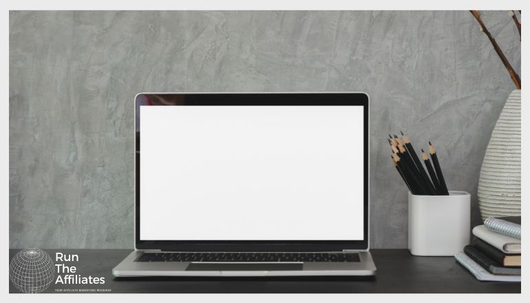 laptop on a desk with a blank screen