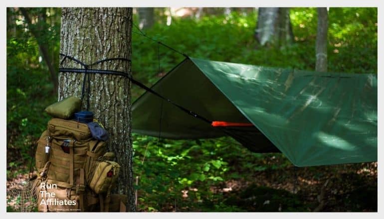 hammock and elevated tent set up in the wilderness