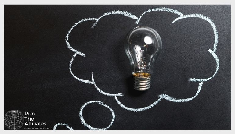 cloud drawn in chalk on a blackboard with a lightbulb in the middle