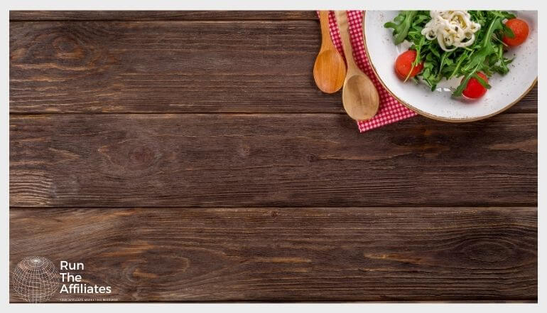 a bowl of salad on a wood table