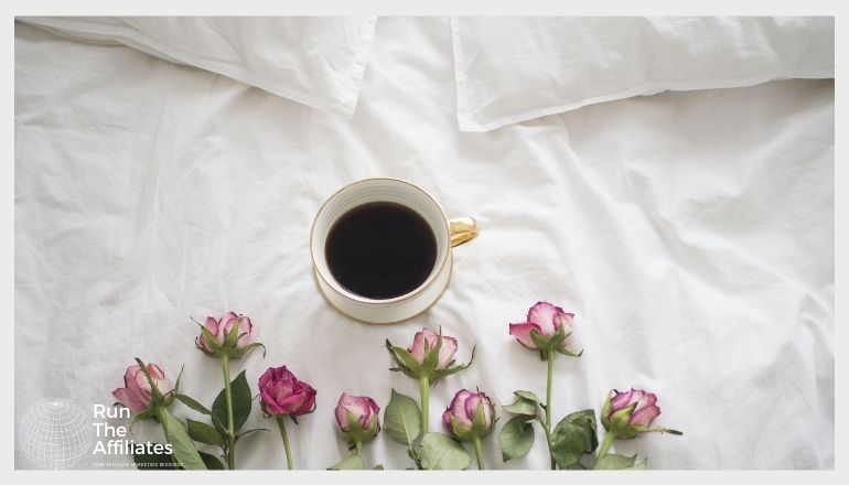 roses and a cup of coffee on a mattress