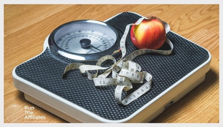 scale with an apple and tape measure on it