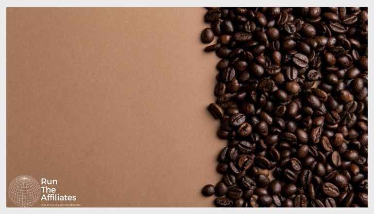 coffee beans on a brown table taking up half the image